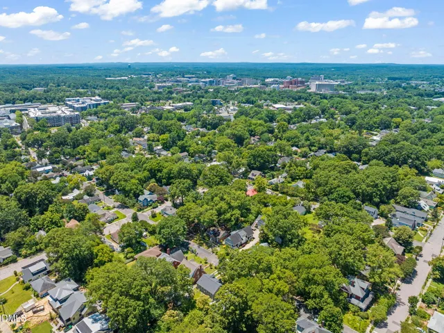 an aerial view of a houses with a yard and lake view
