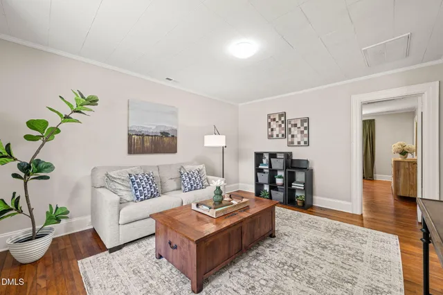 a living room with furniture and wooden floor