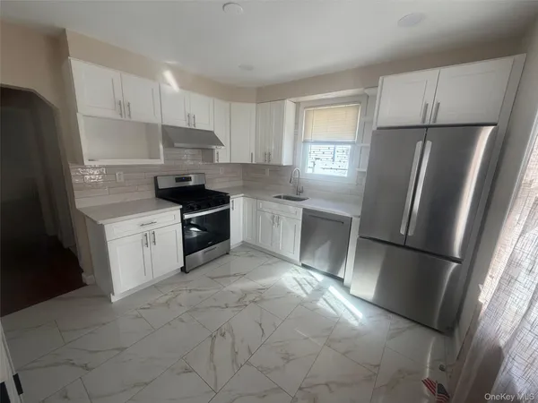 a kitchen with a refrigerator a sink and a stove