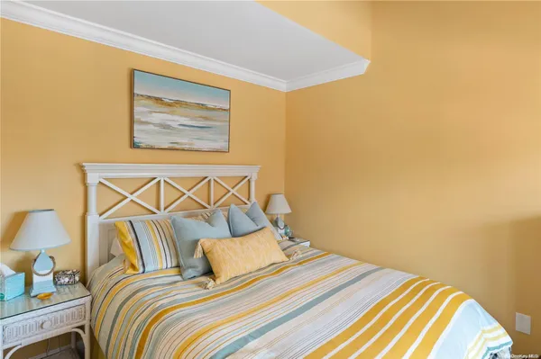 a bedroom with a bed and lamp