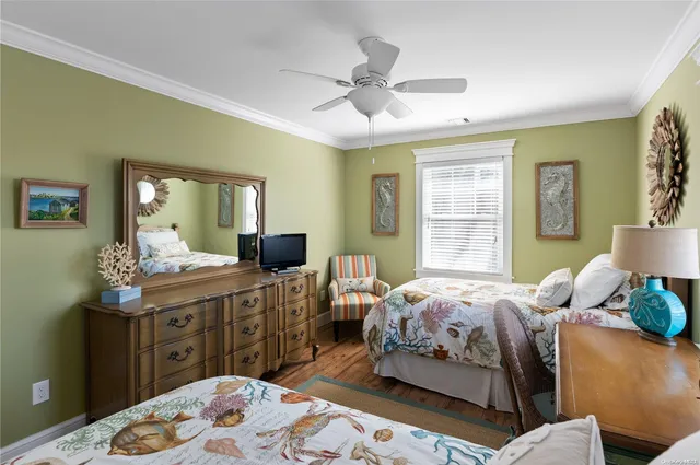 a bedroom with two beds and a dresser