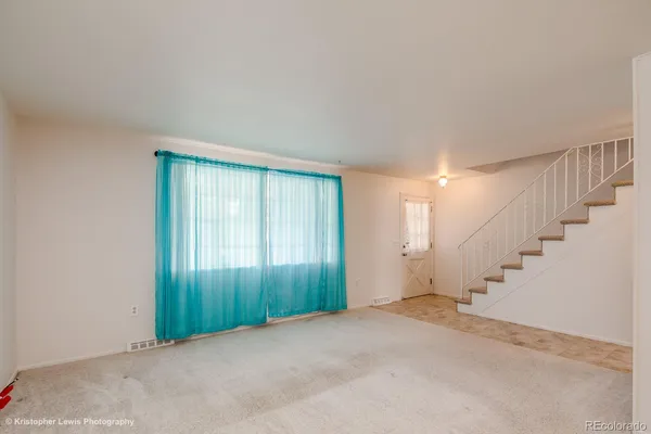 a view of an empty room with stairs