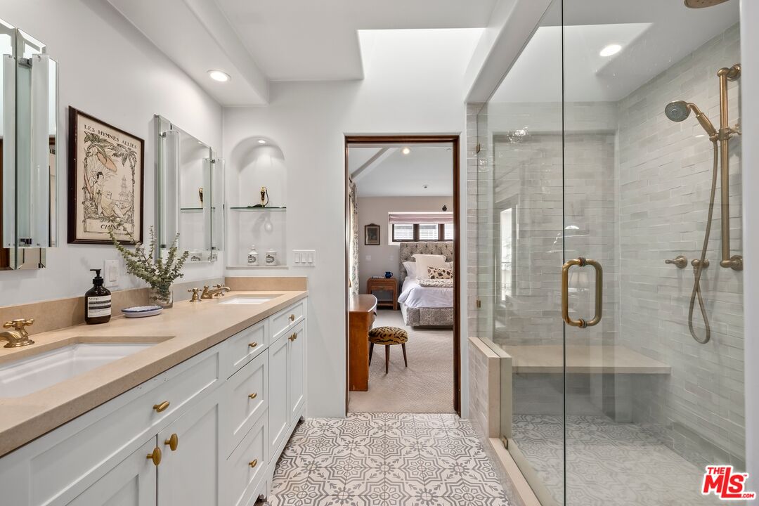 849 14th Street, Unit 8 Santa Monica, CA 90403 - Photo 10 of 19 a spacious bathroom with a shower sink and mirror