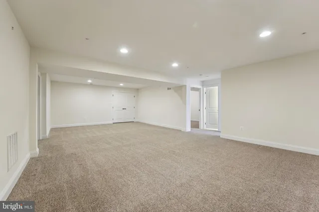 a view of a room with wooden floor and iron stairs