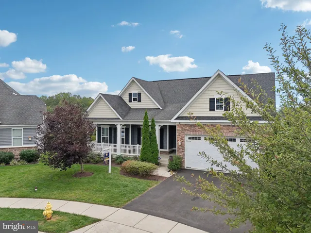 an aerial view of a house with garden space and street view