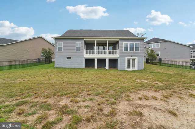 a view of a tennis ground with furniture