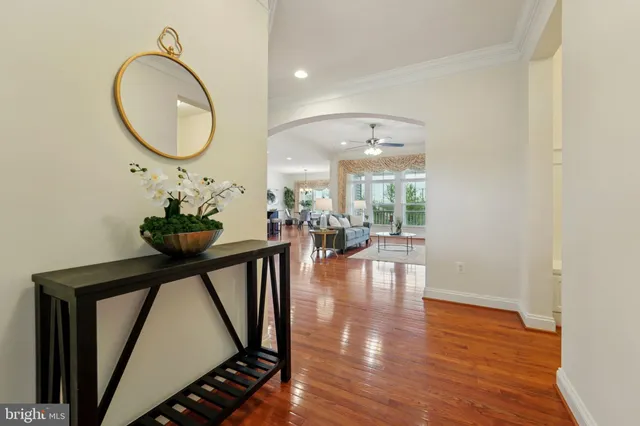 an entryway with wooden floor and a chandelier