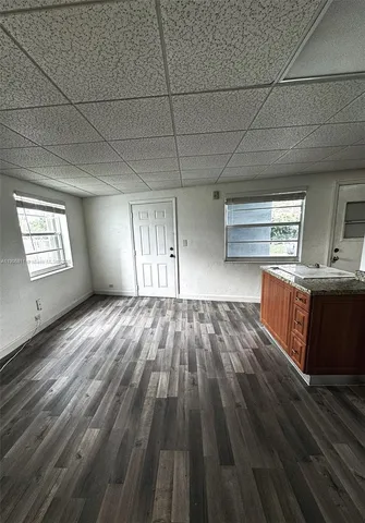 a view of wooden floor and windows in a room