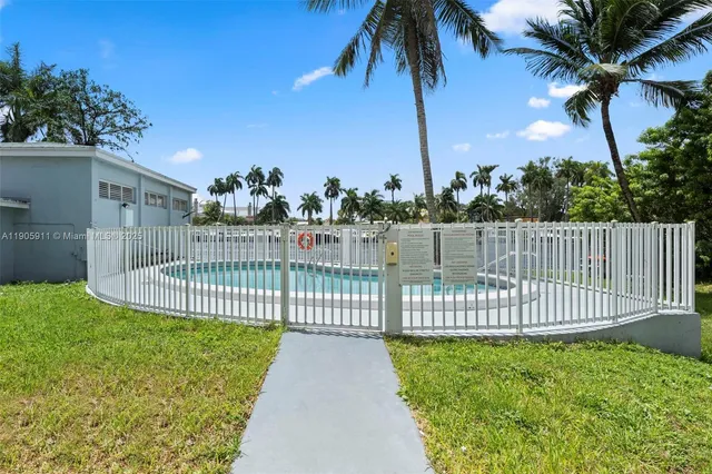 a view of a street with a garden