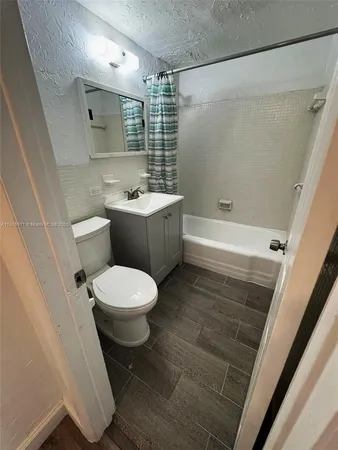 a bathroom with a toilet a sink and bathtub