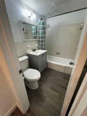 a bathroom with a toilet a sink and bathtub