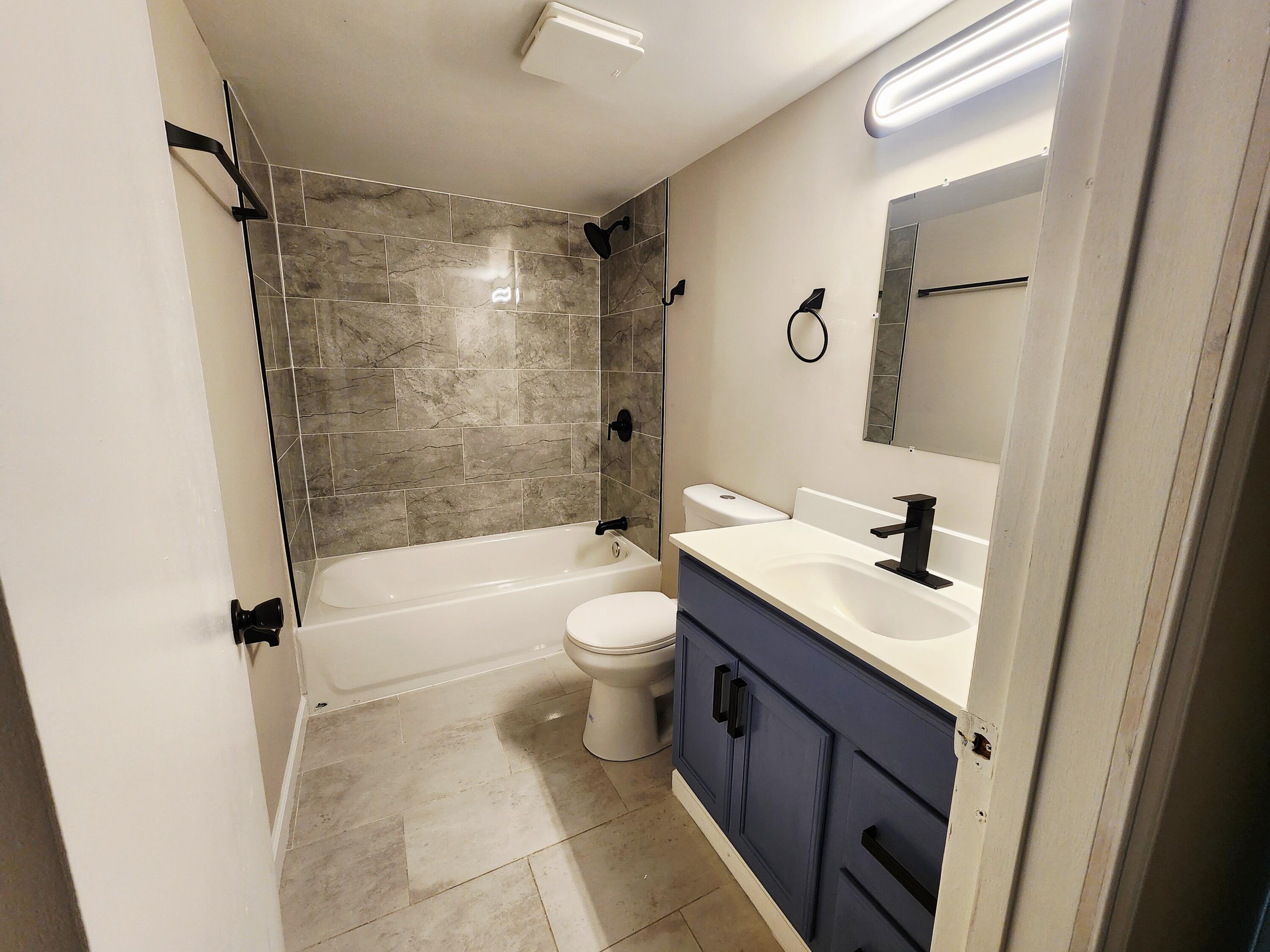 653 West Taft Street Gary, IN 46404 - Photo 14 of 16 a bathroom with a granite countertop sink toilet a shower and a mirror