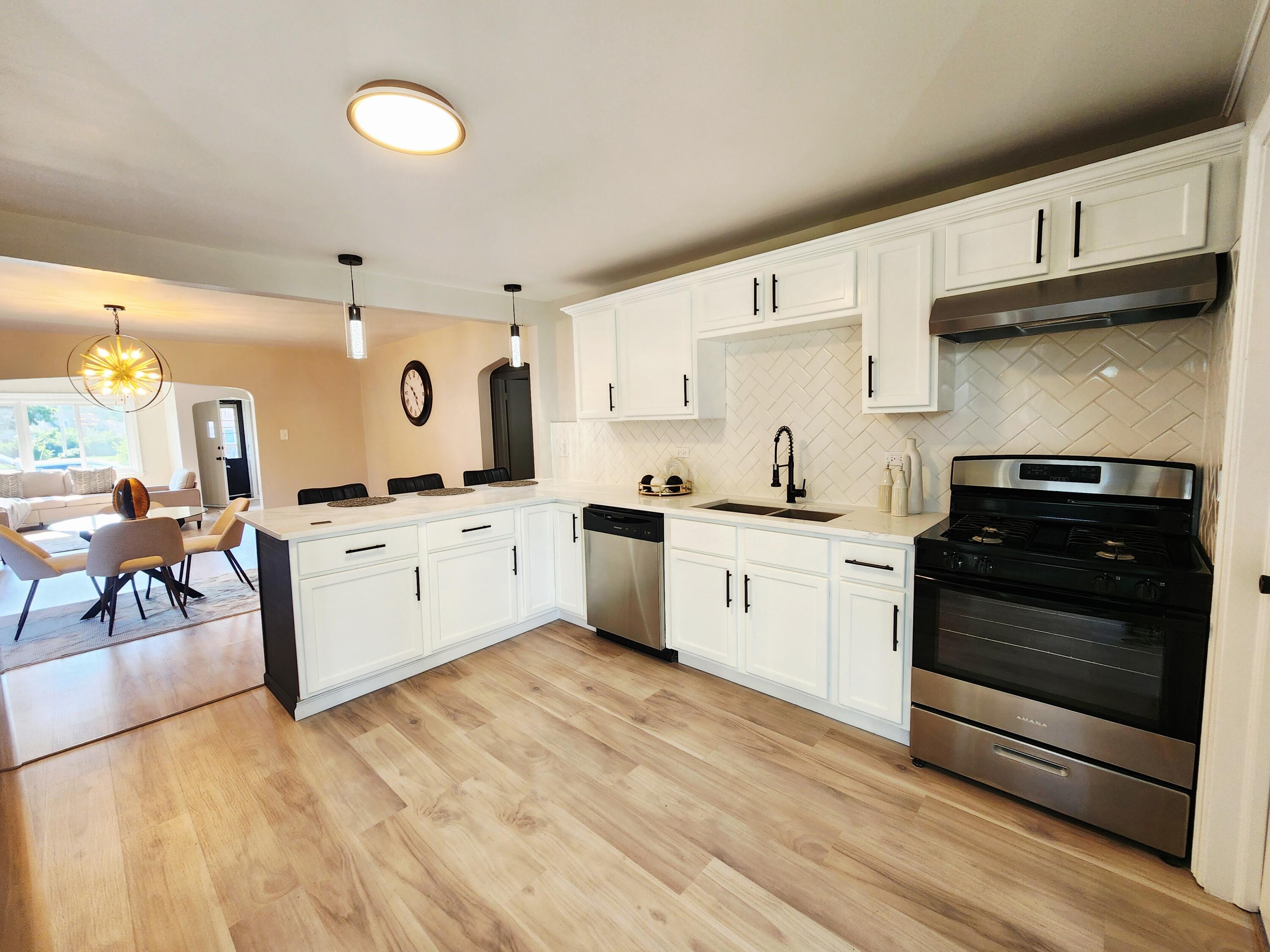 653 West Taft Street Gary, IN 46404 - Photo 6 of 16 a kitchen with stainless steel appliances a stove a sink and a refrigerator