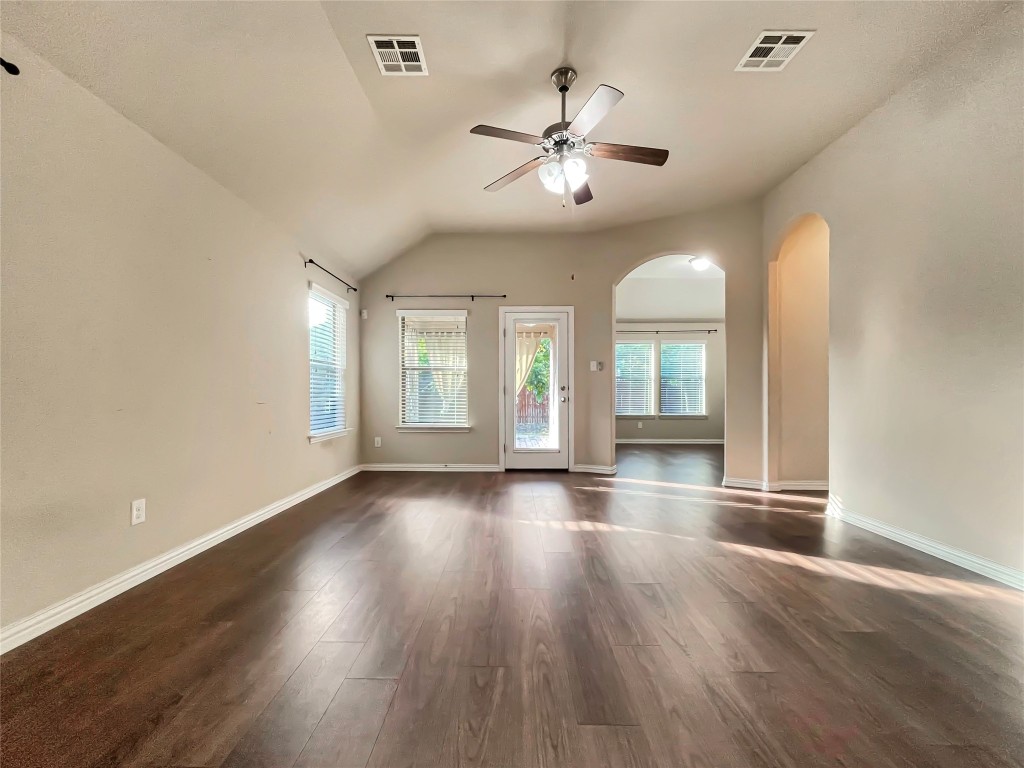 2468 Millbrook Loop Leander, TX 78641 - Photo 11 of 16 a view of an empty room with wooden floor and a window