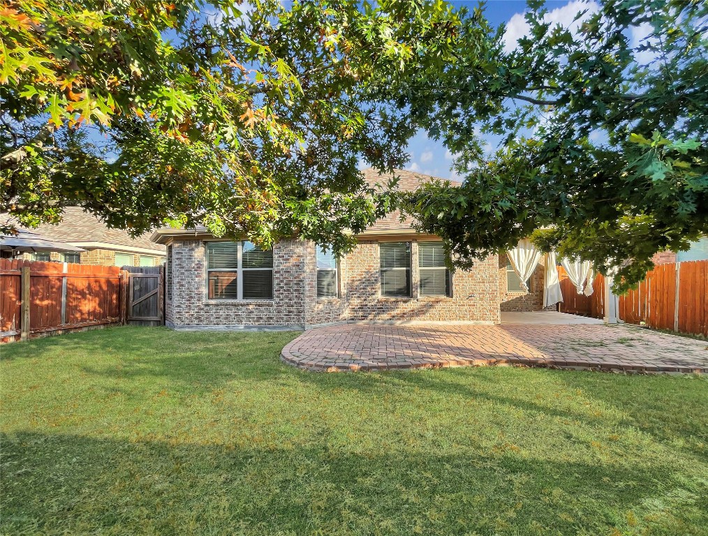 2468 Millbrook Loop Leander, TX 78641 - Photo 15 of 16 a front view of a house with a garden