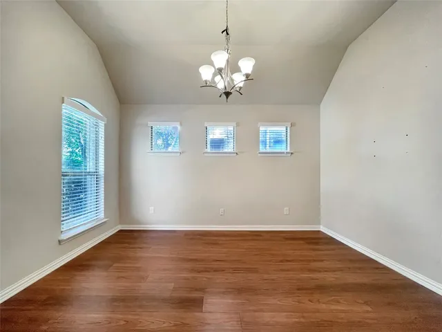 a view of wooden floor and chandelier in a room