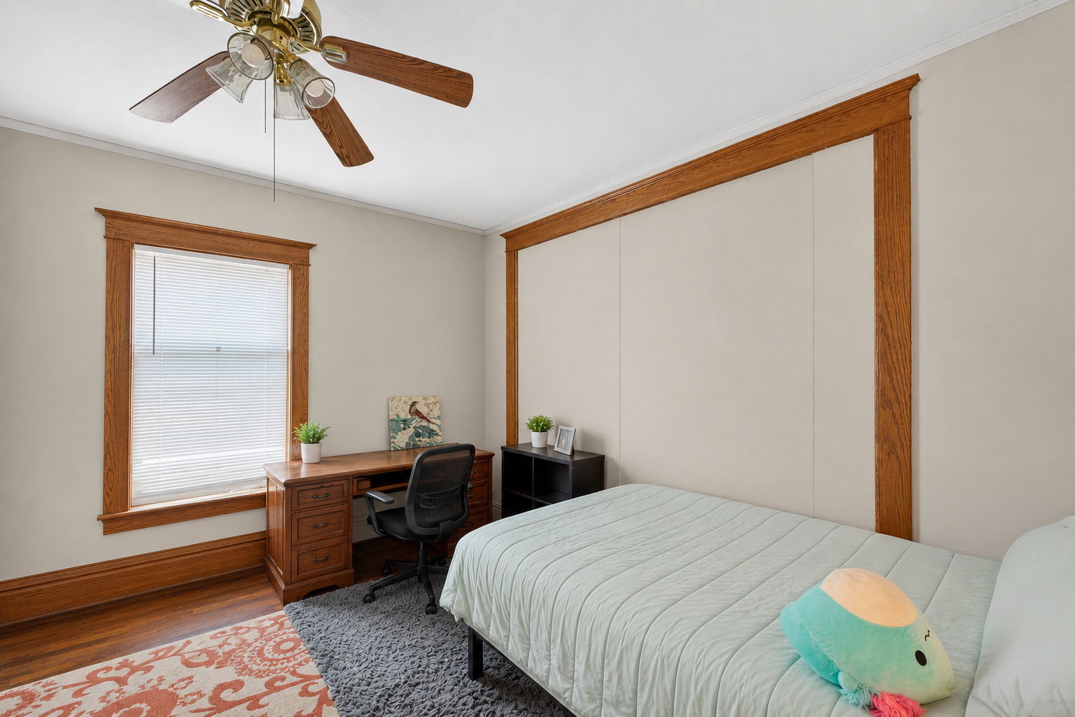 226 West Locust Street DeKalb, IL 60115 - Photo 9 of 40 a bedroom with a bed and a chandelier