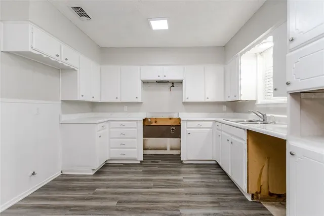 a kitchen with white cabinets and white appliances