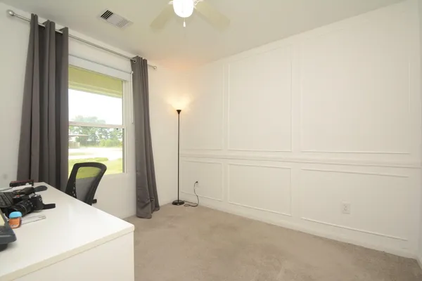 a view of a room that has a bed and a window