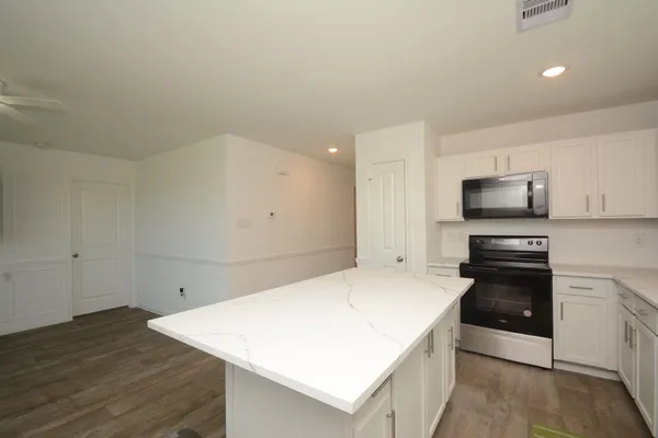 a kitchen with a sink a stove and microwave