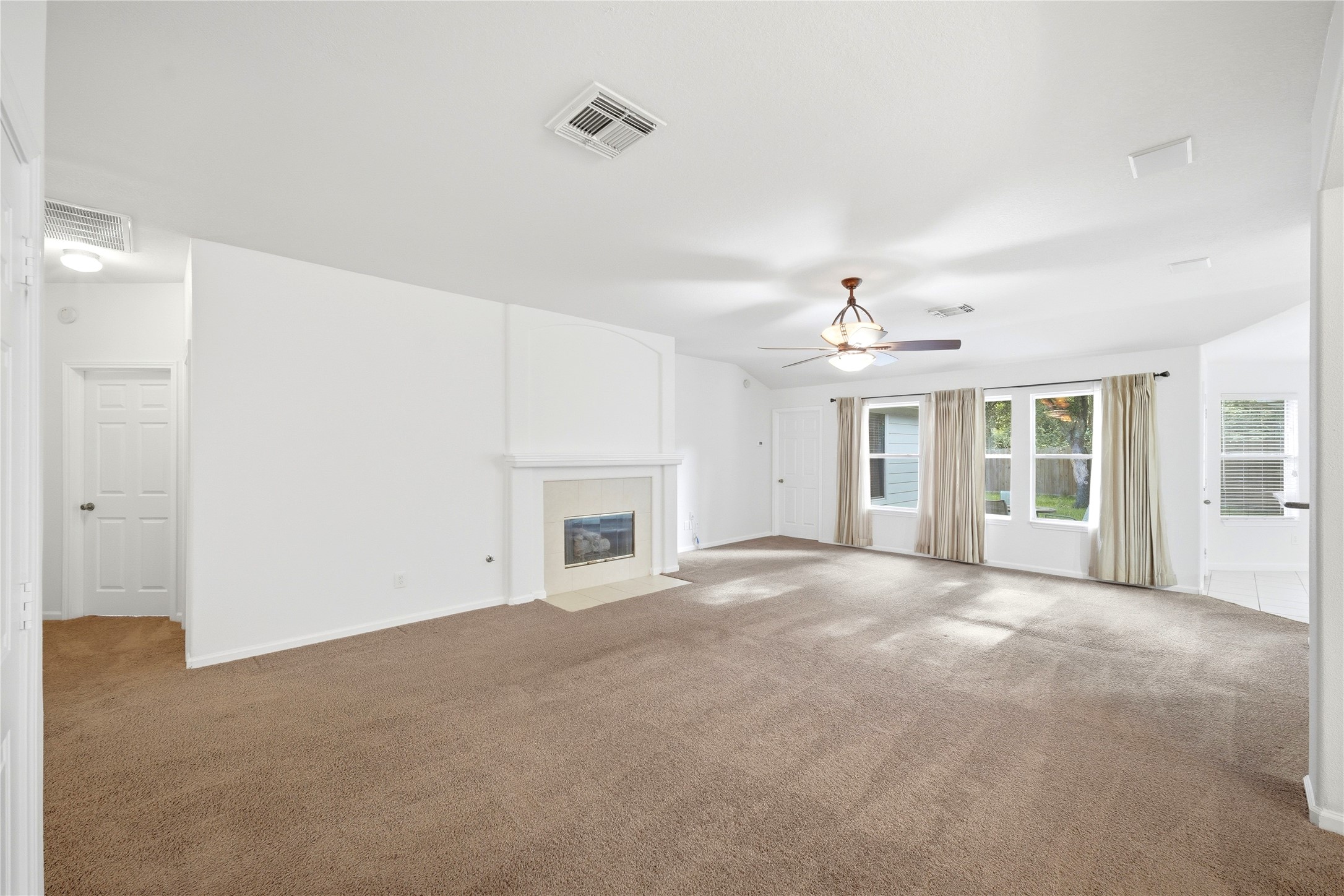 5411 Gate Canyon Court Spring, TX 77373 - Photo 7 of 33 a view of an empty room with chandelier fan and fire place