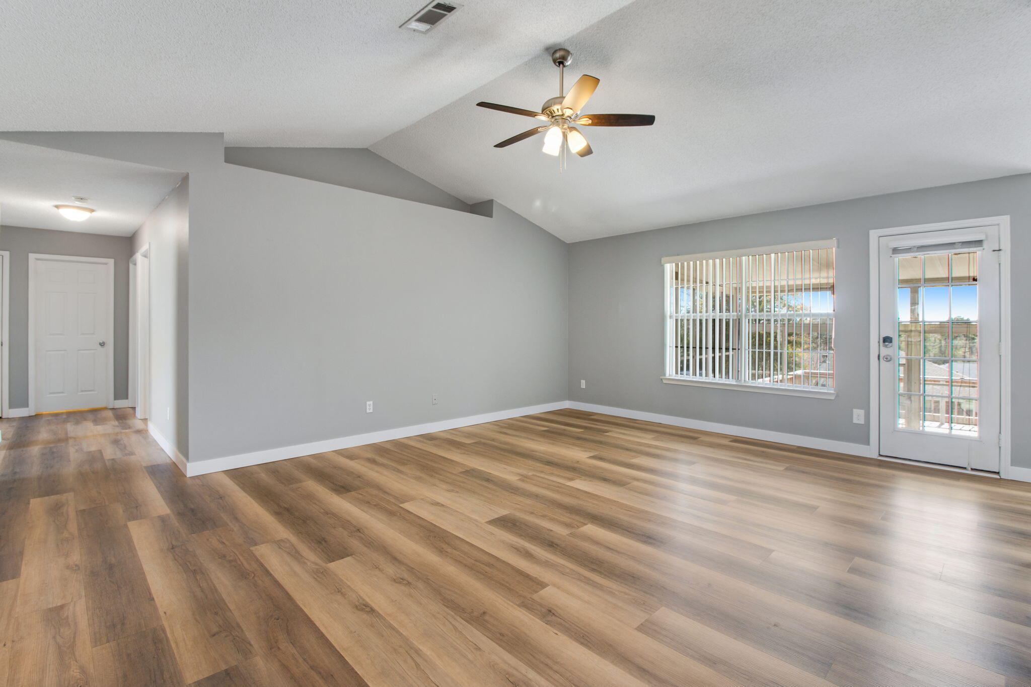 5130 Whitehurst Lane Crestview, FL 32536 - Photo 11 of 49 a view of an empty room with a window and wooden floor