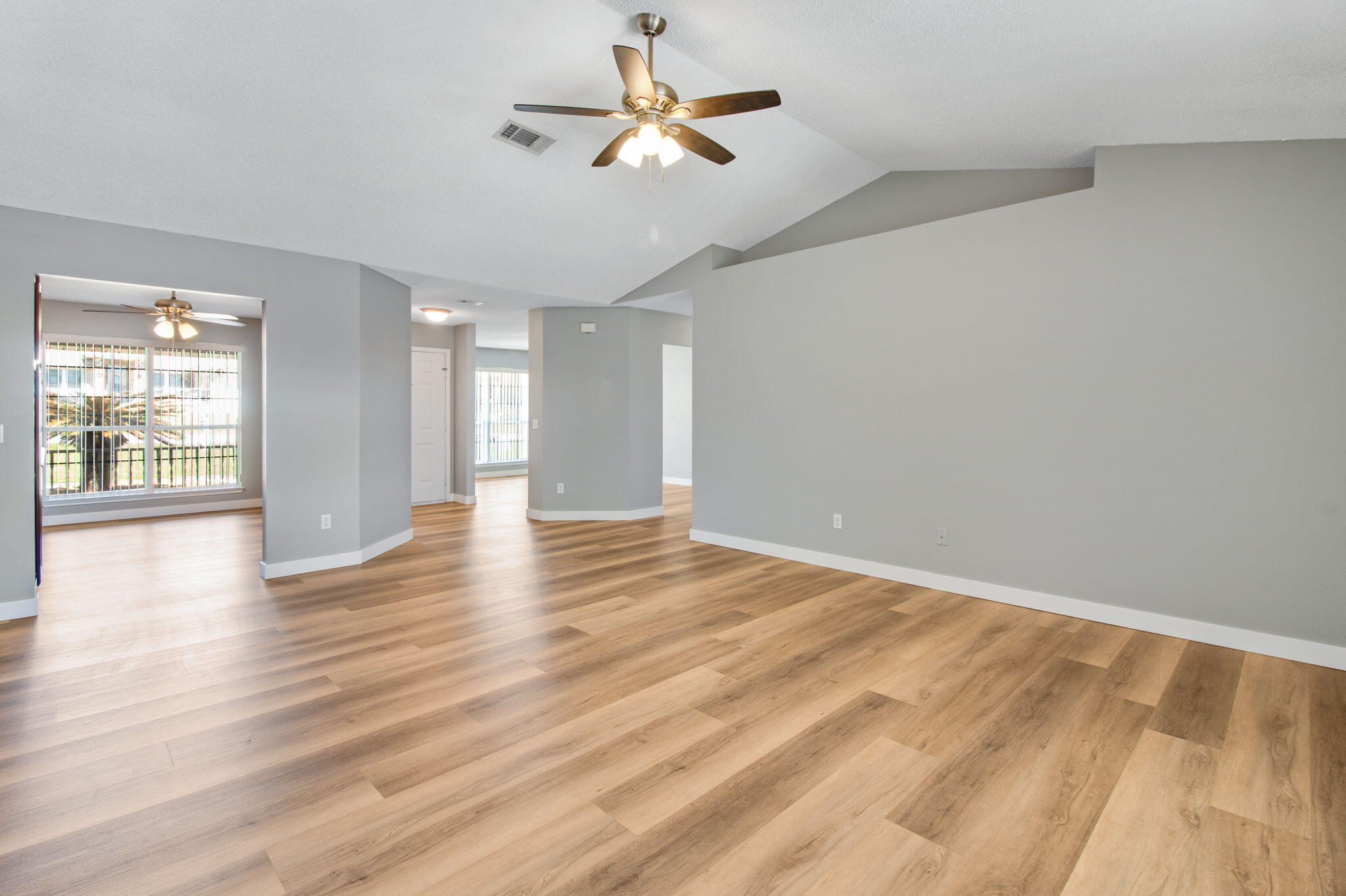 5130 Whitehurst Lane Crestview, FL 32536 - Photo 13 of 49 a view of an empty room with window and wooden floor