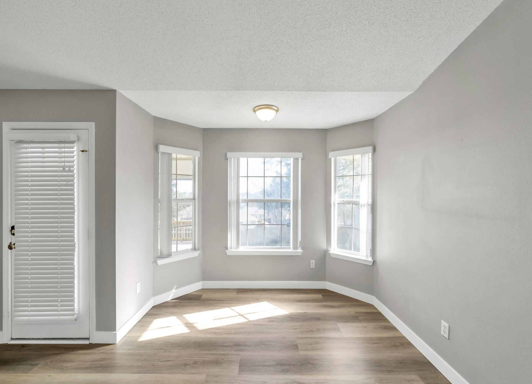 5130 Whitehurst Lane Crestview, FL 32536 - Photo 15 of 49 an empty room with wooden floor and windows