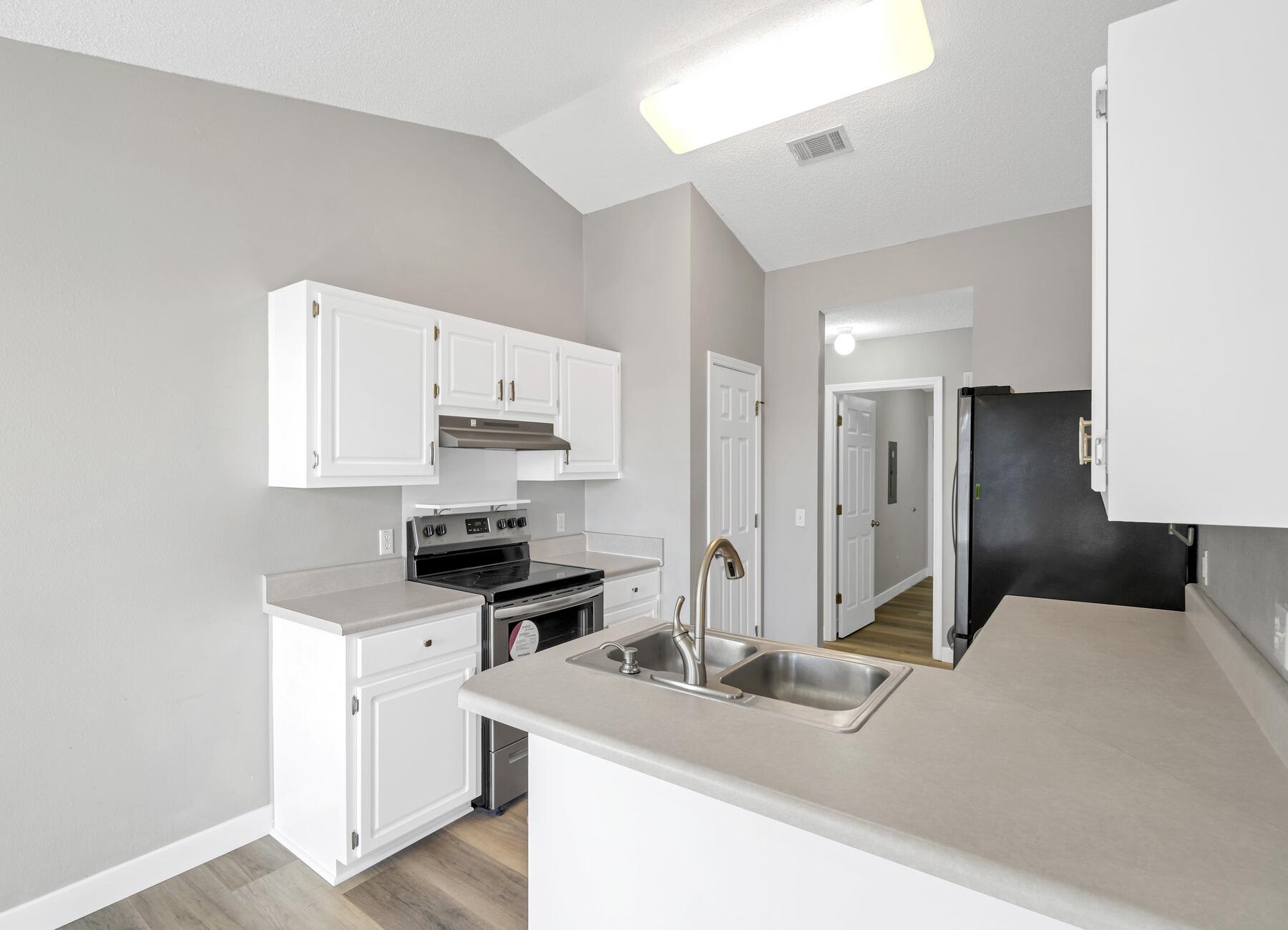 5130 Whitehurst Lane Crestview, FL 32536 - Photo 17 of 49 a kitchen with stainless steel appliances a stove refrigerator sink and cabinets