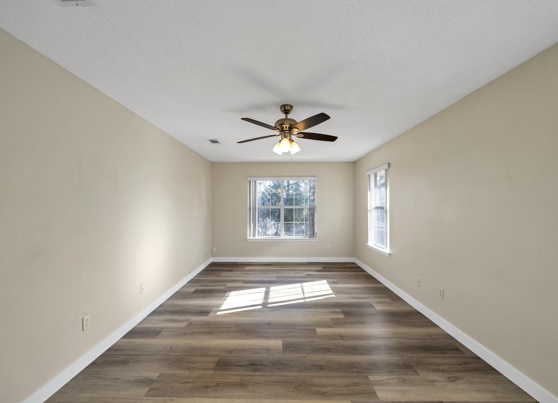 5130 Whitehurst Lane Crestview, FL 32536 - Photo 23 of 49 a view of empty room with wooden floor and fan