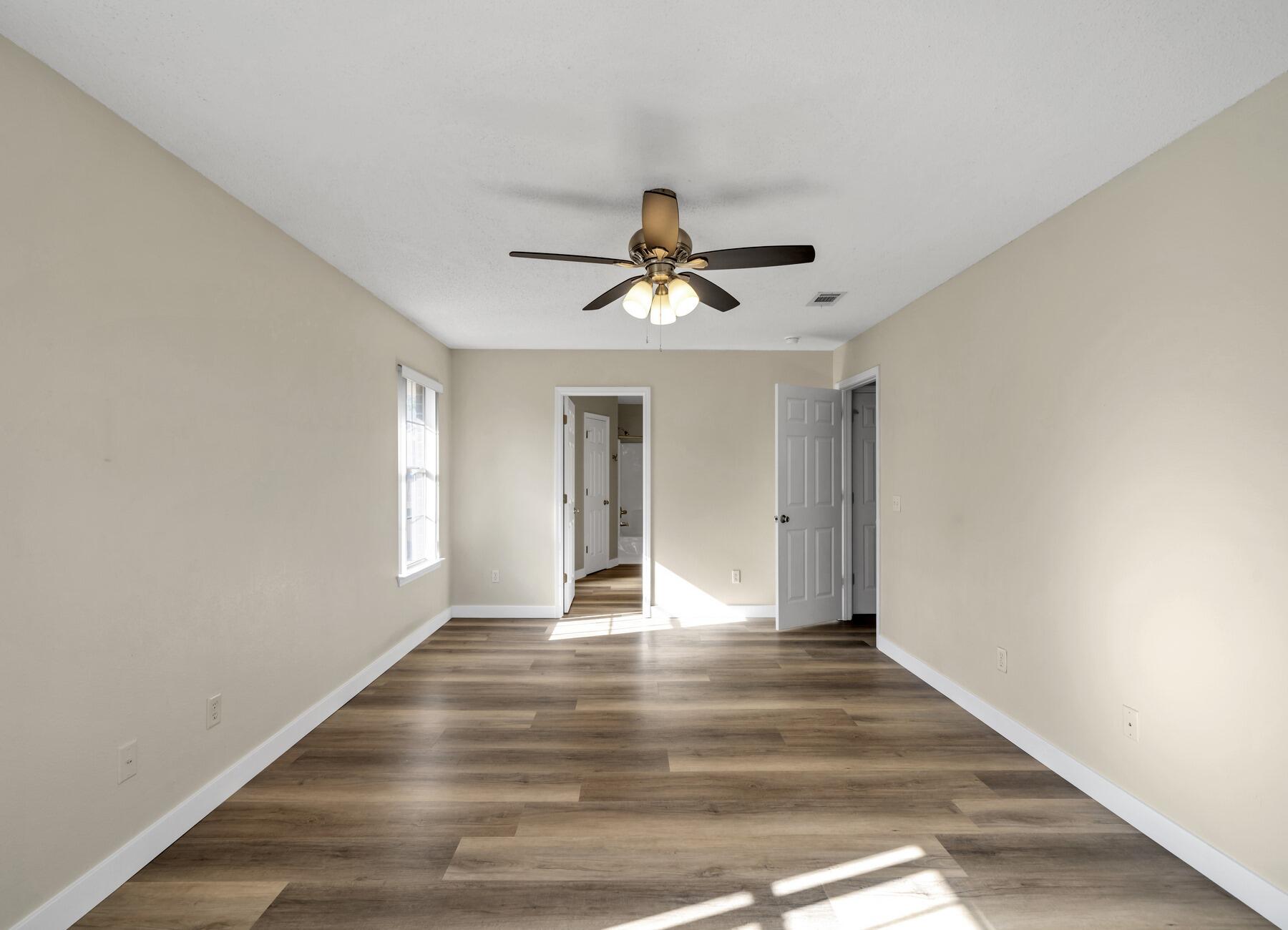 5130 Whitehurst Lane Crestview, FL 32536 - Photo 24 of 49 a view of empty room with wooden floor and fan