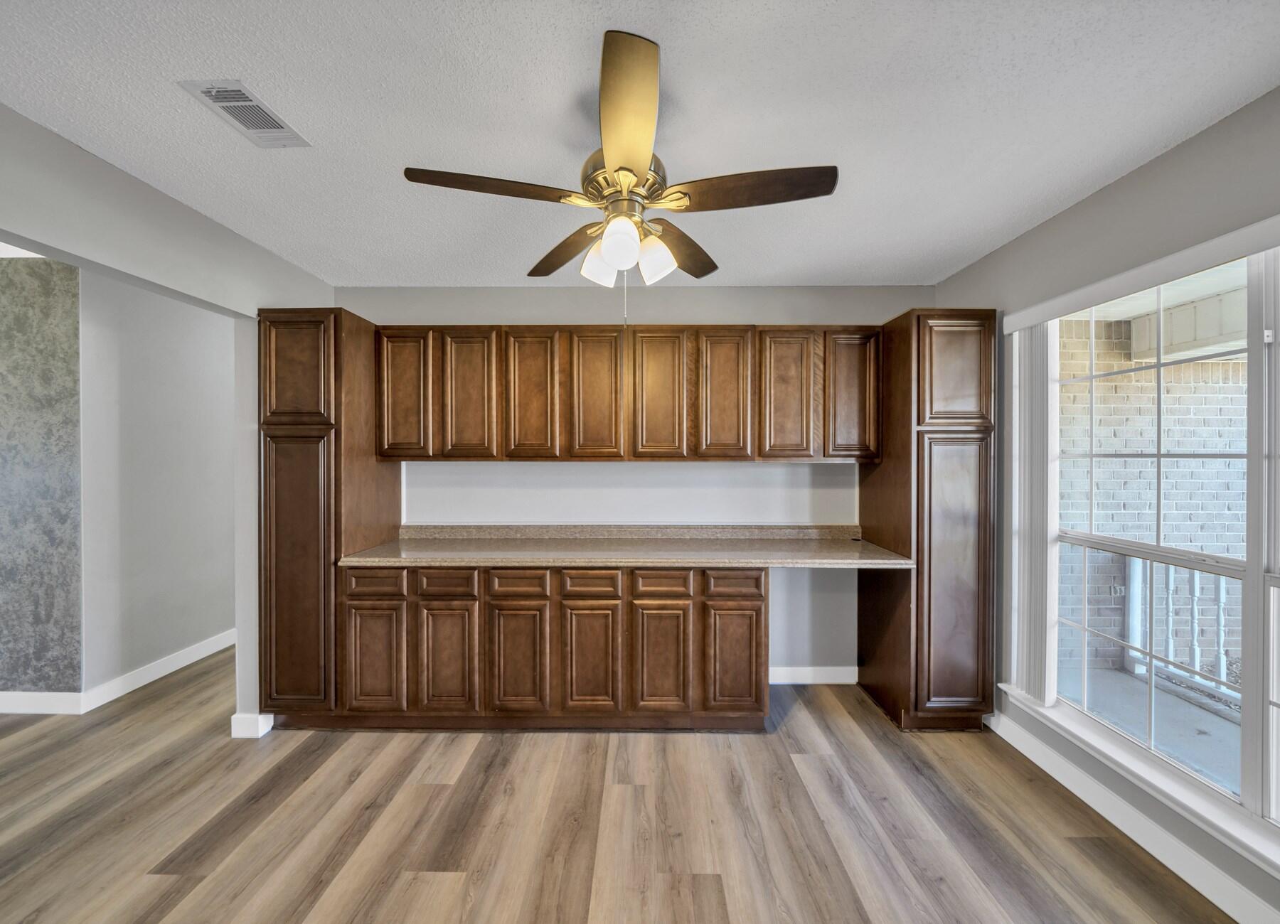 5130 Whitehurst Lane Crestview, FL 32536 - Photo 4 of 49 a view of a kitchen with a sink and wooden cabinets