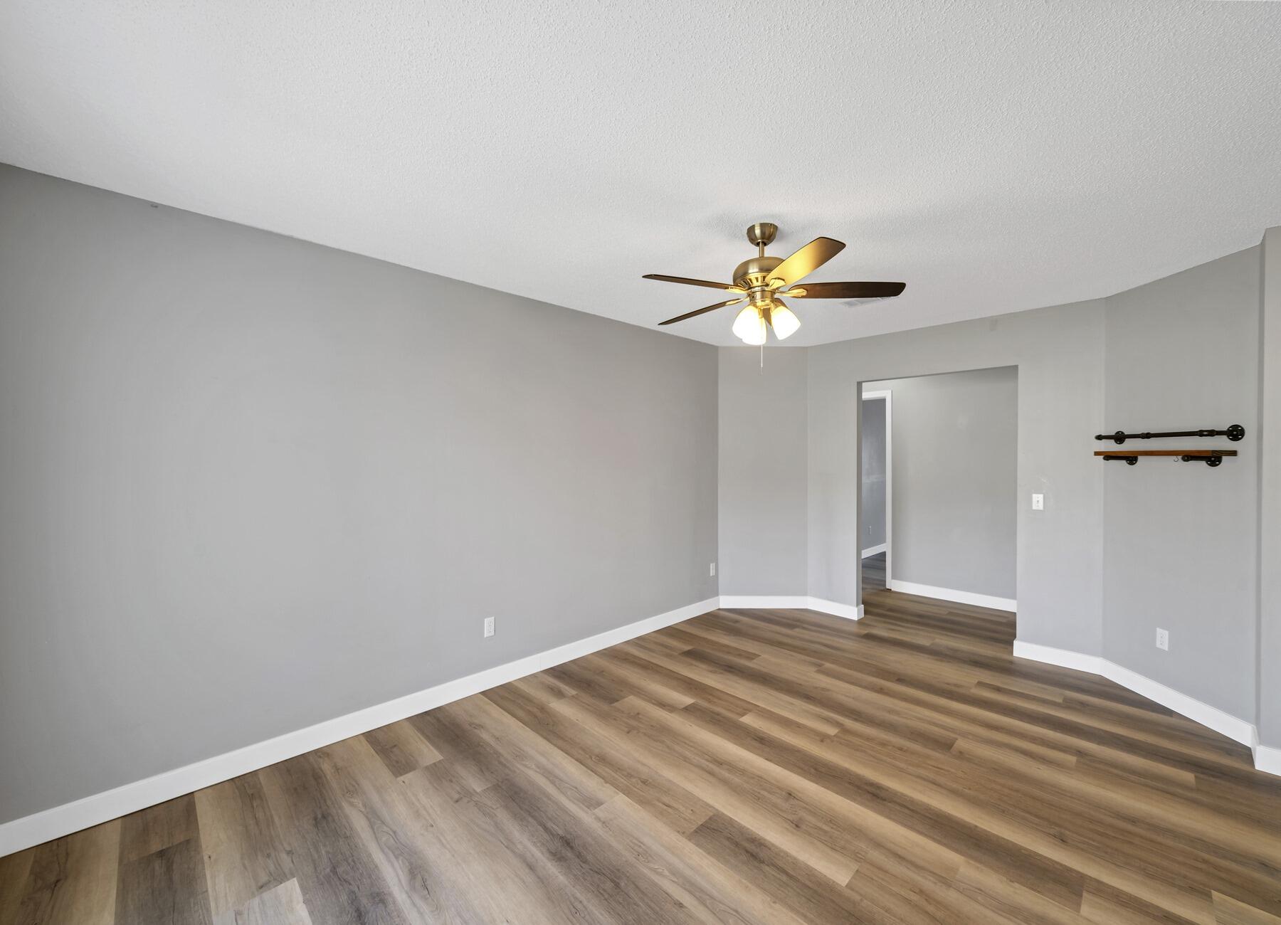 5130 Whitehurst Lane Crestview, FL 32536 - Photo 7 of 49 a bedroom with a bed and a chandelier