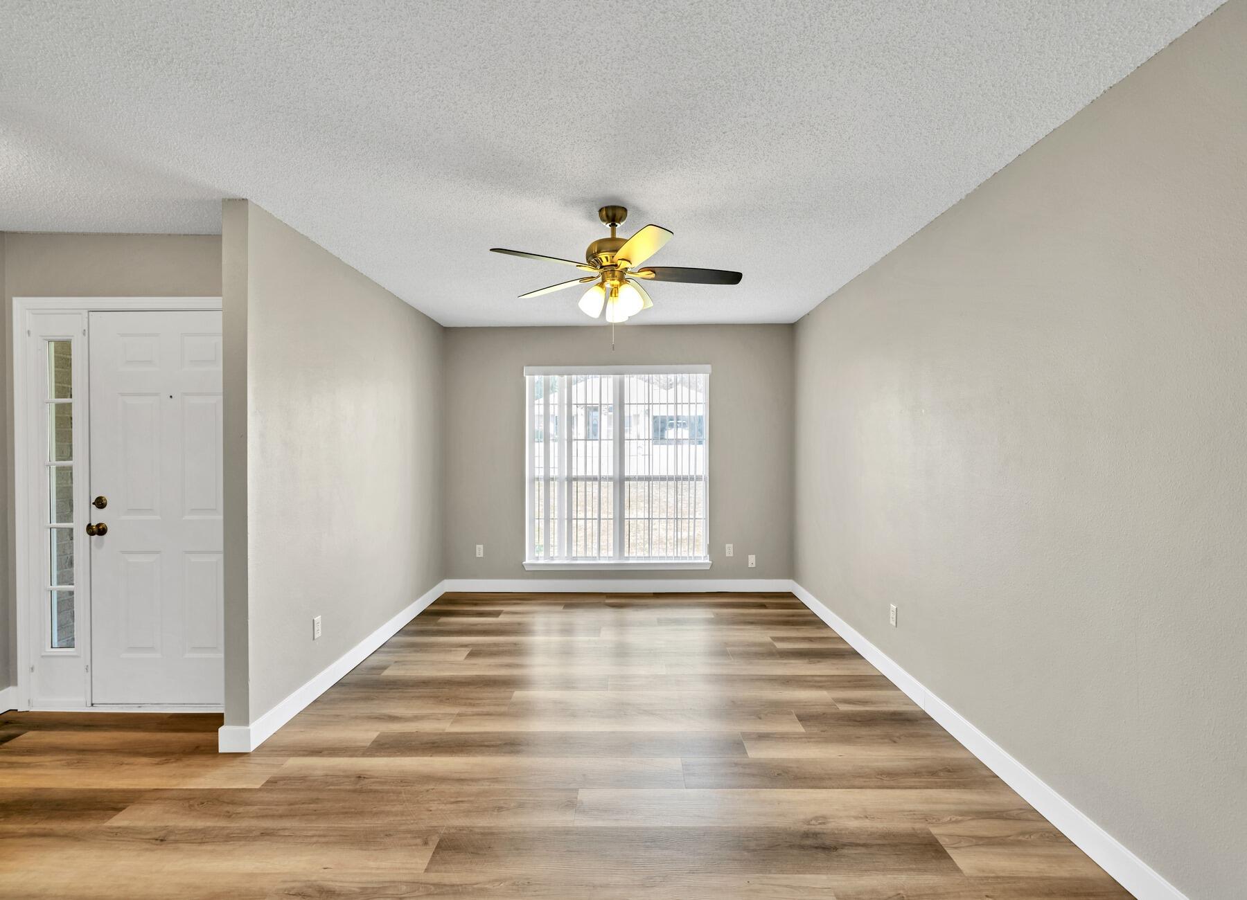 5130 Whitehurst Lane Crestview, FL 32536 - Photo 8 of 49 a view of an empty room with wooden floor and a window