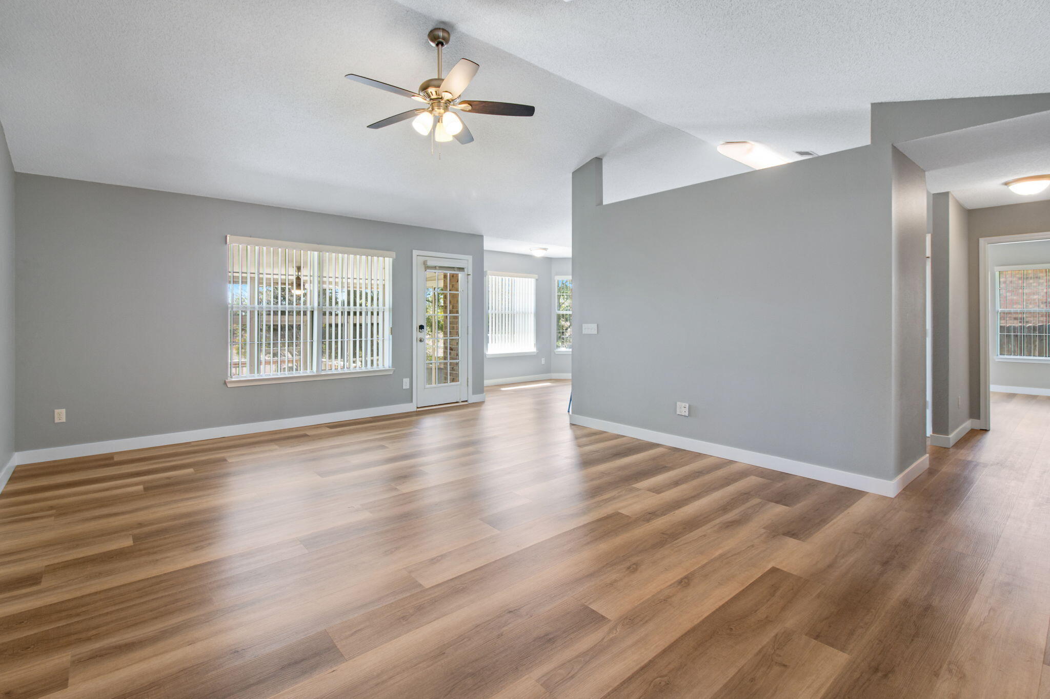5130 Whitehurst Lane Crestview, FL 32536 - Photo 9 of 49 a view of an empty room with a window and wooden floor