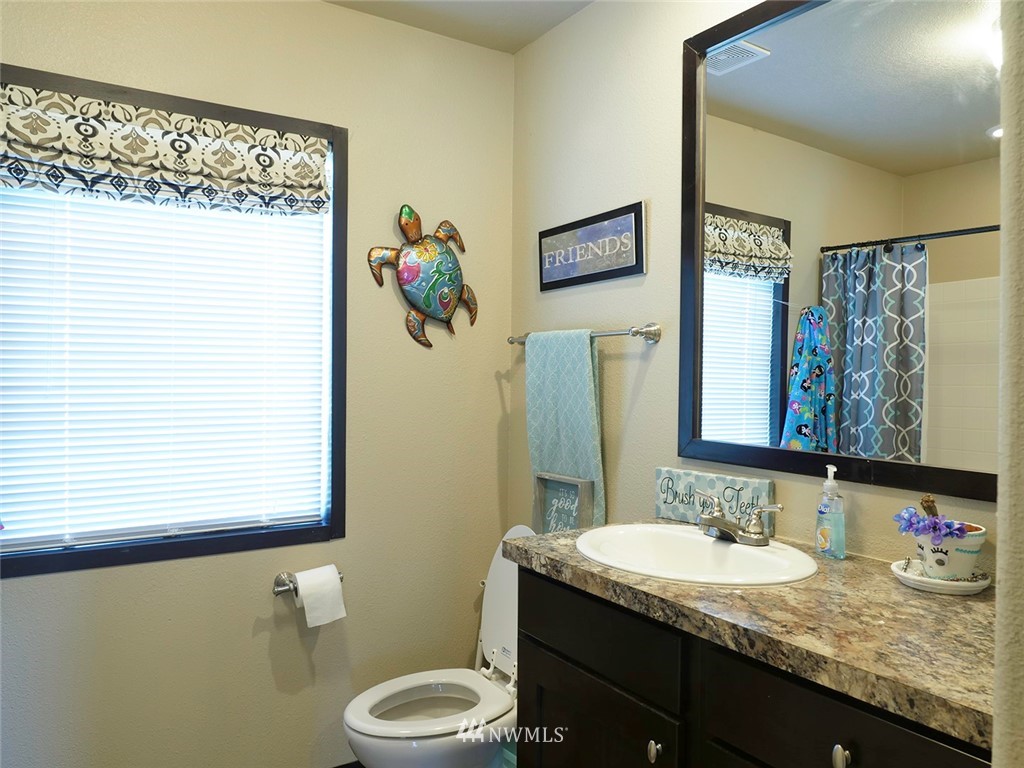 55 Old Goat Lane Sequim, WA 98382 - Photo 18 of 32 a bathroom with a granite countertop sink mirror vanity and toilet