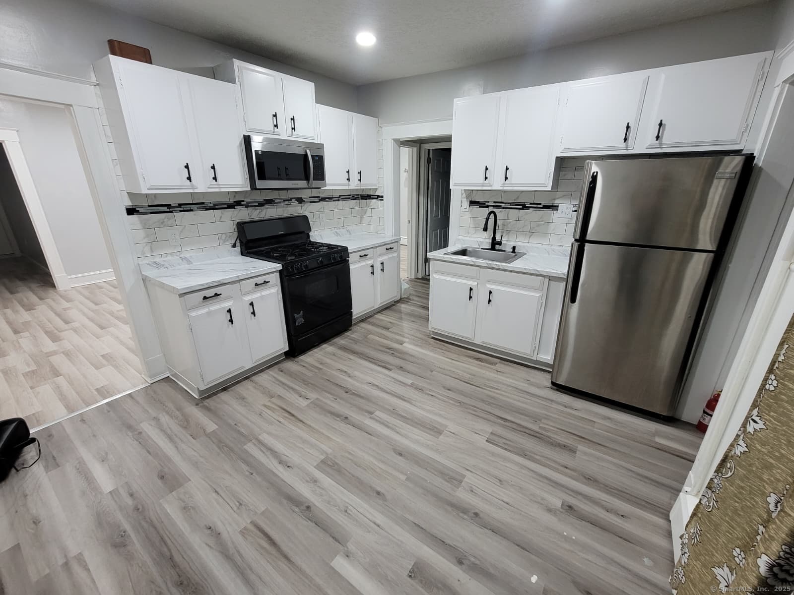 120 Brown Street, Unit 1 Hartford, CT 06114 - Photo 2 of 6 a kitchen with a refrigerator a stove top oven a sink and dishwasher