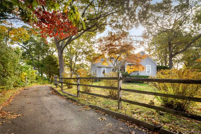 a view of a yard with wooden fence