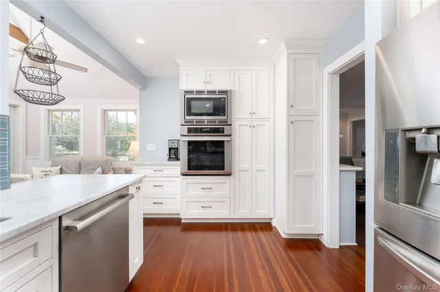 a kitchen with a sink cabinets stainless steel appliances and window