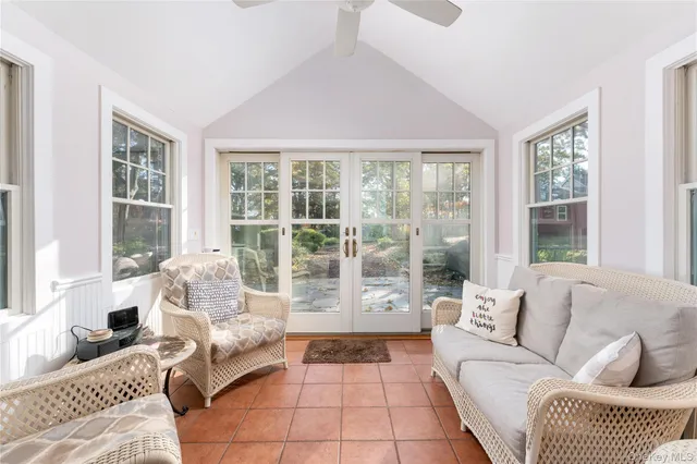 a living room with furniture and floor to ceiling windows