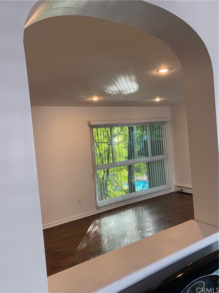 11767 Sunset Boulevard, Unit 202 Los Angeles, CA 90049 - Photo 15 of 23 a view of room with window and wooden floor
