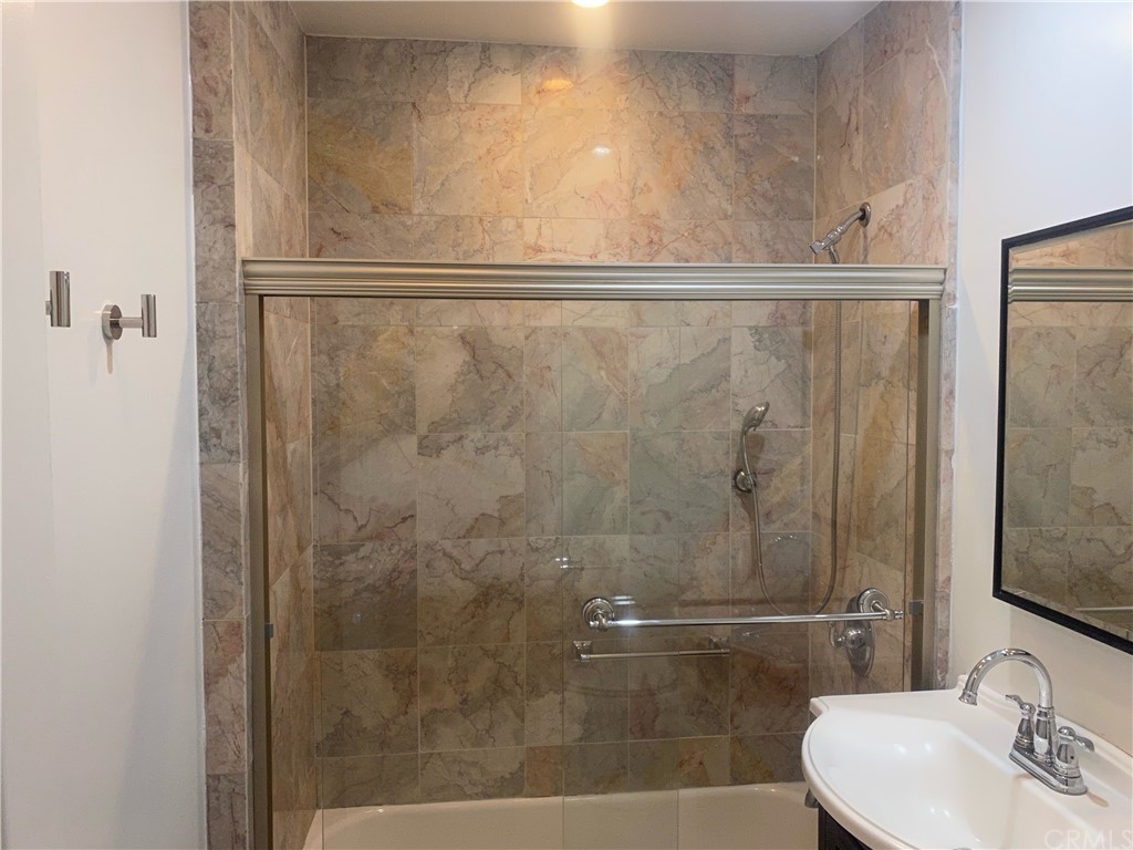 11767 Sunset Boulevard, Unit 202 Los Angeles, CA 90049 - Photo 18 of 23 a bathroom with a shower and a sink