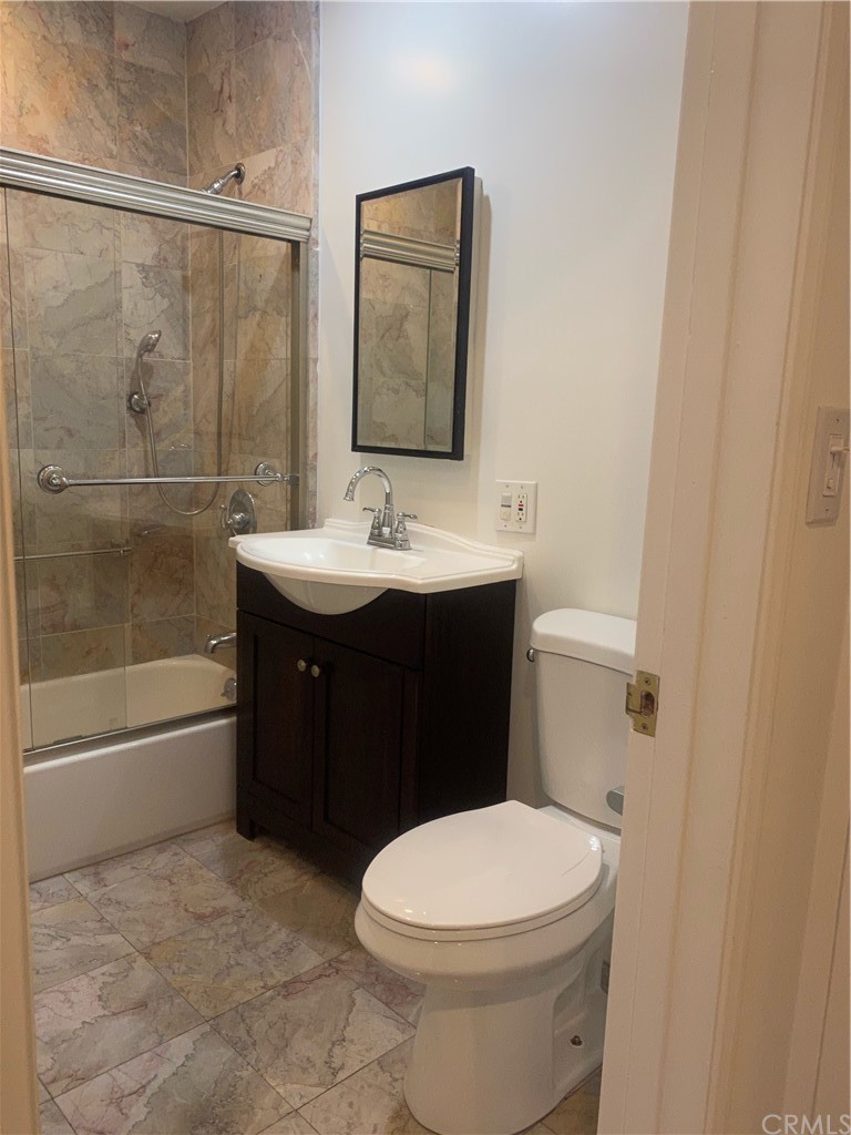 11767 Sunset Boulevard, Unit 202 Los Angeles, CA 90049 - Photo 19 of 23 a bathroom with a sink a toilet and shower