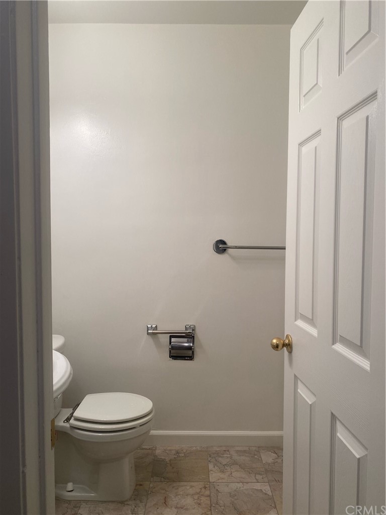 11767 Sunset Boulevard, Unit 202 Los Angeles, CA 90049 - Photo 21 of 23 a white toilet sitting next to a shower