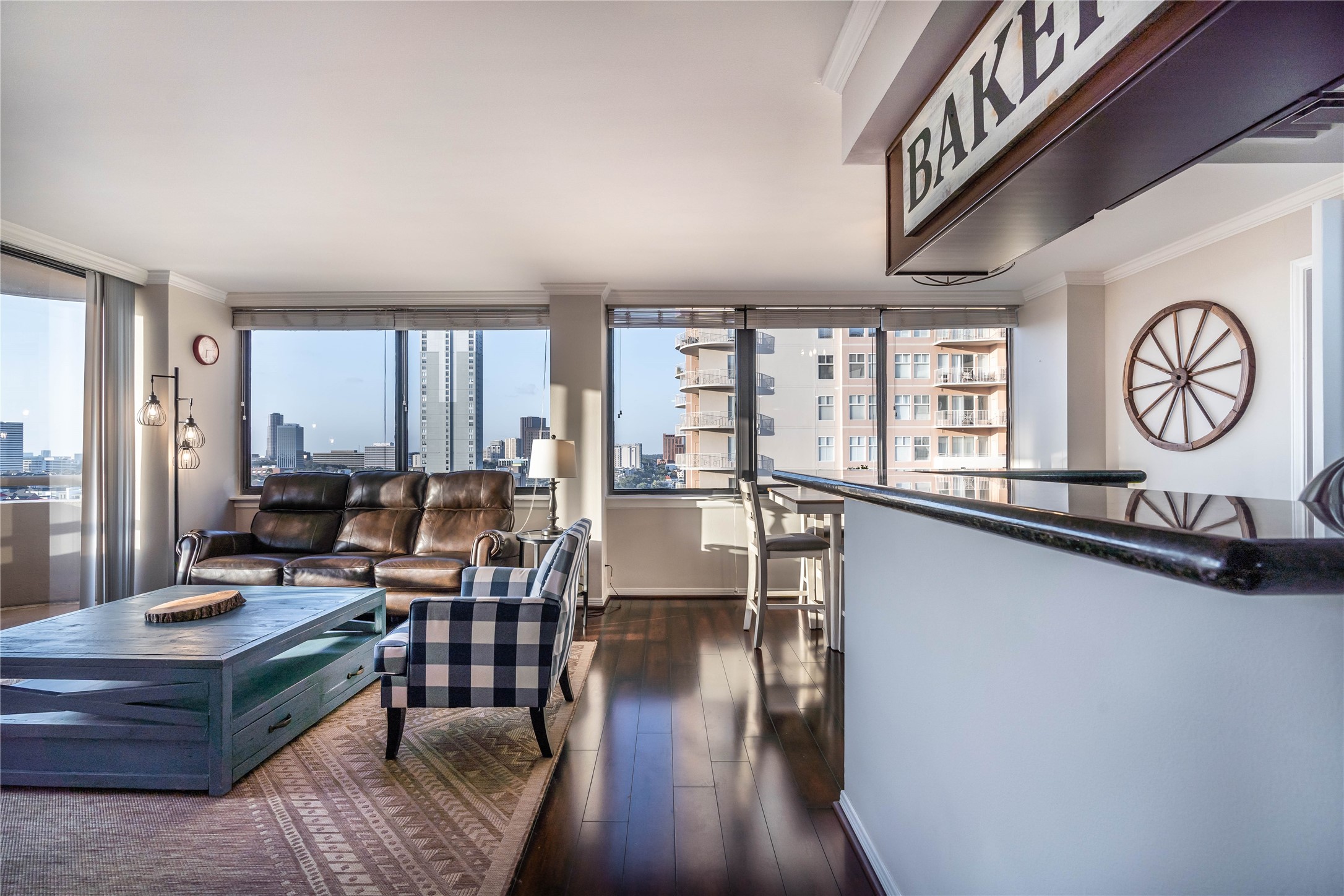 3525 Sage Road, Unit 1315 Houston, TX 77056 - Photo 1 of 23 a living room with furniture a large window and wooden floor
