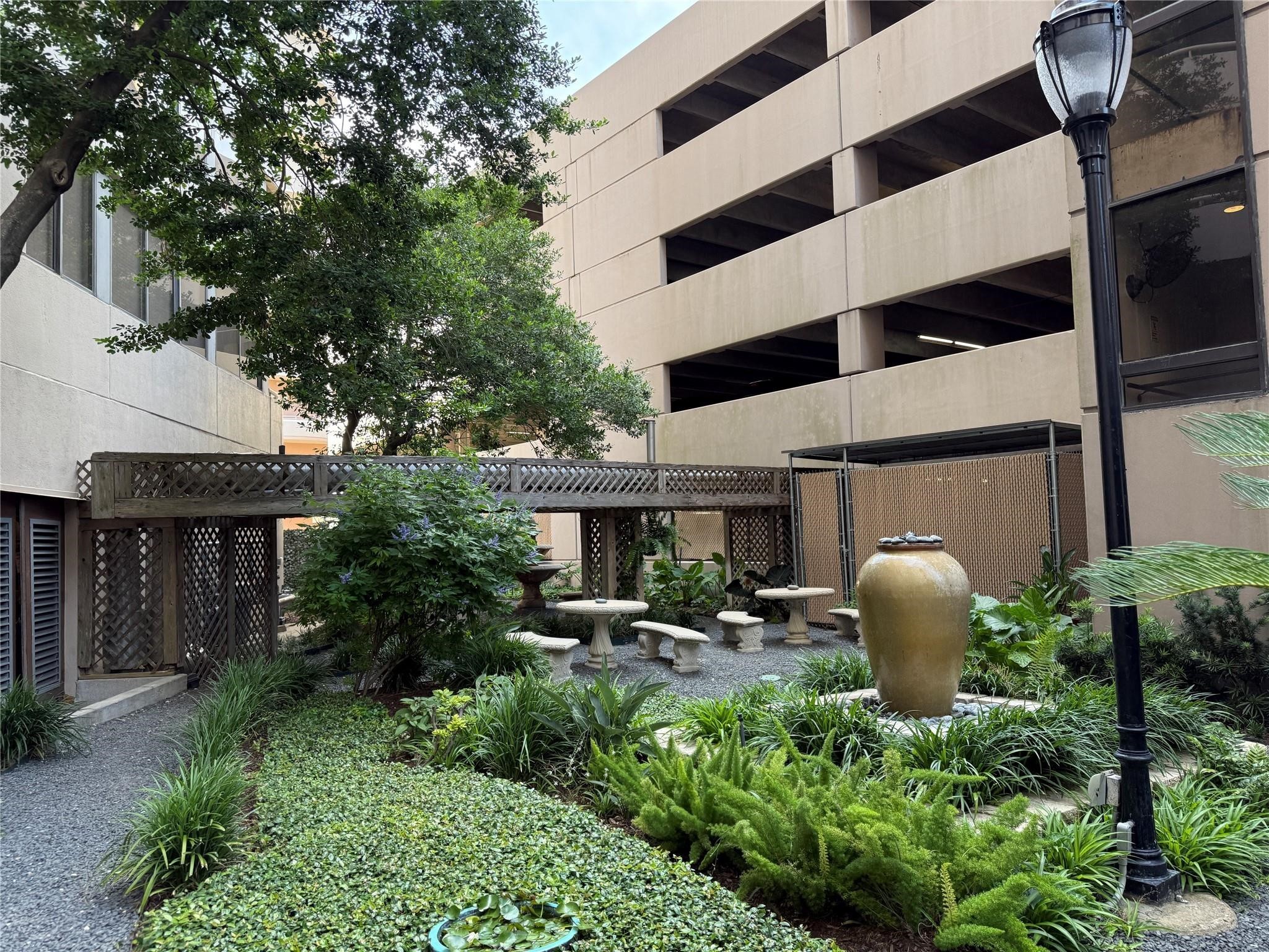 3525 Sage Road, Unit 1315 Houston, TX 77056 - Photo 22 of 23 a view of a patio with table and chairs and potted plants