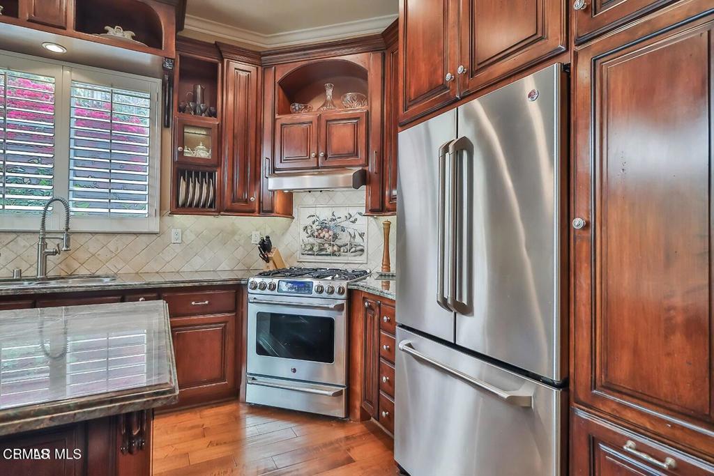963 Corte Augusta Camarillo, CA 93010 - Photo 11 of 27 a kitchen with stainless steel appliances granite countertop a refrigerator and a sink