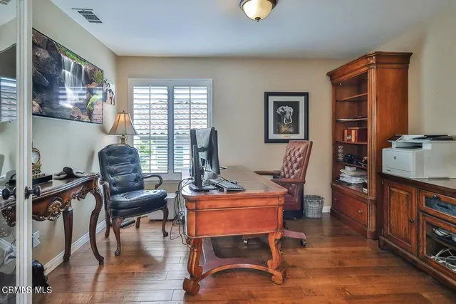 a large bed sitting in a bedroom next to a window