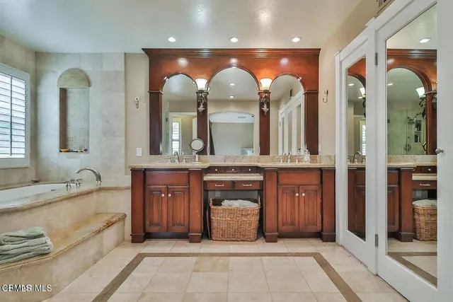 a spacious bathroom with a tub shower and sink