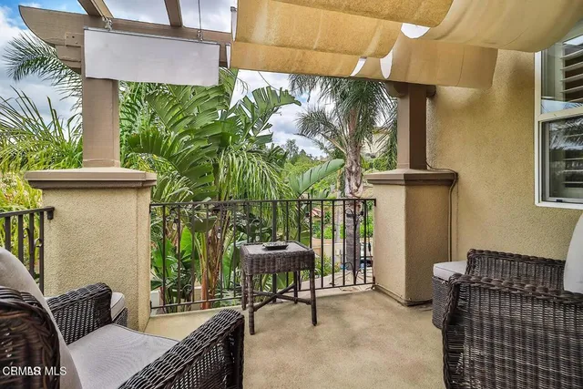 a view of a patio with couches table and chairs and potted plants